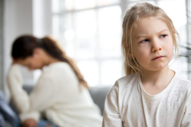 Angry sulking girl ignoring mom